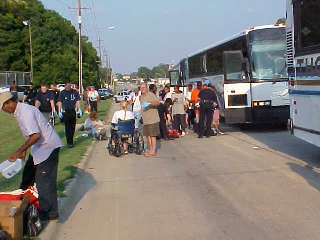 People arriving by bus to Hurricane Katrina shelters.